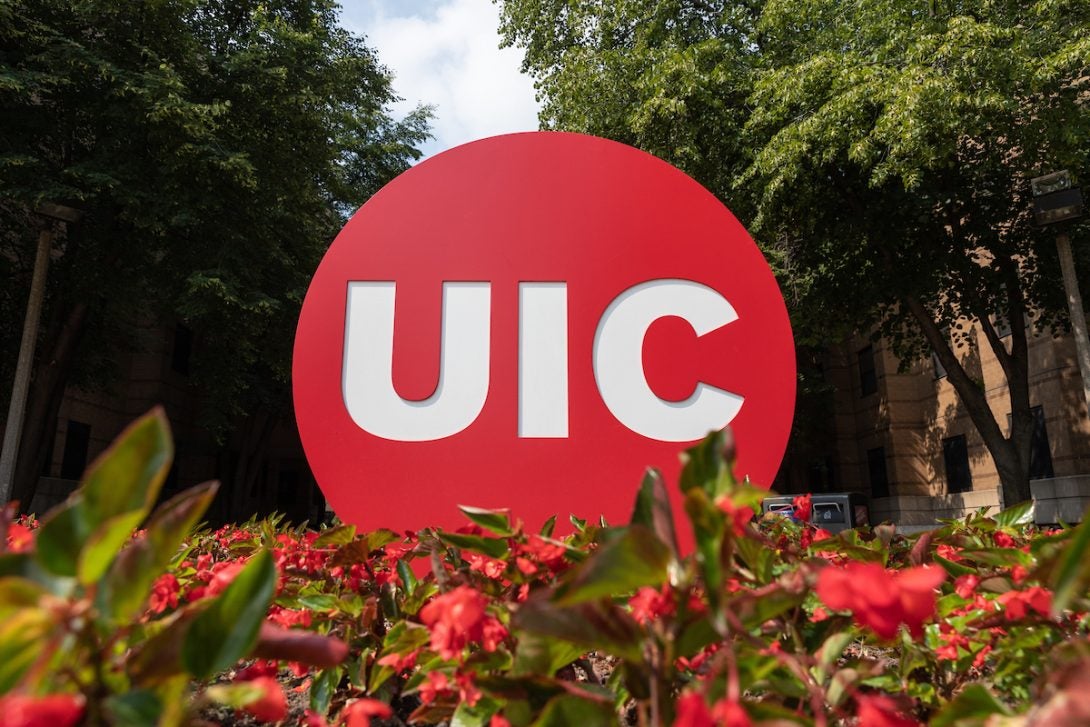 UIC logo outside in front of flowers