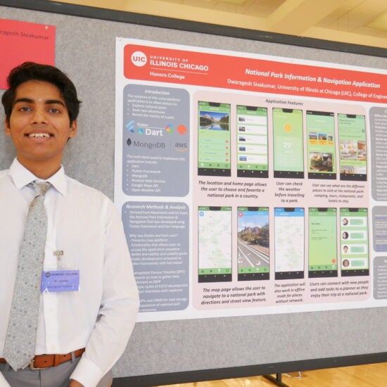 Student smiling and presenting their capstone research project