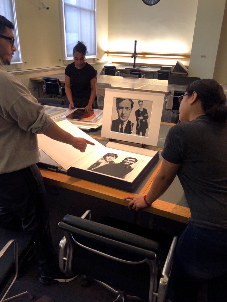 Students looking at images in a museum