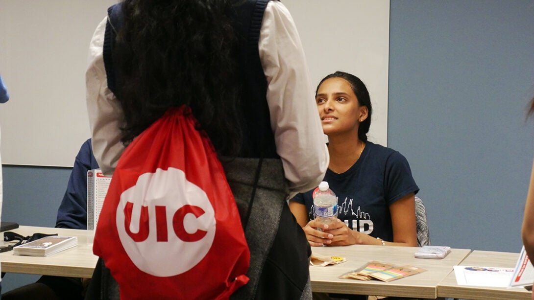 The Honors College logo as seen at the college on a students bag while talking to an Honors member