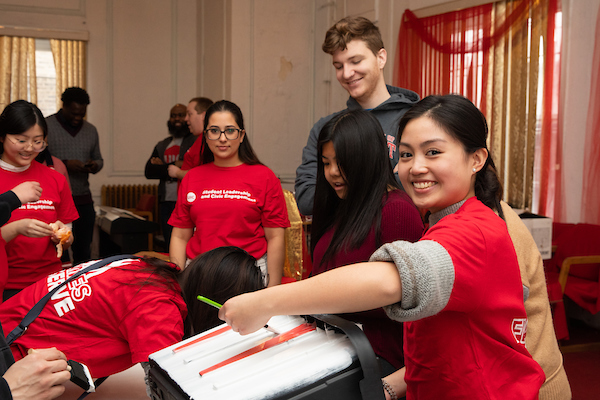 Students in red volunteering