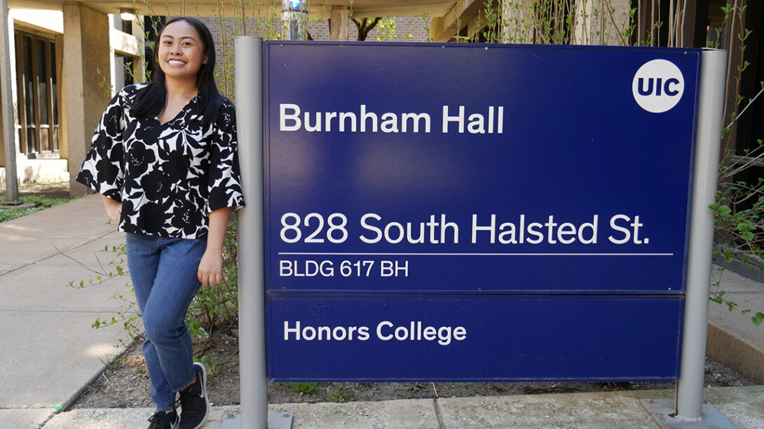 Student standing by Burnham Hall