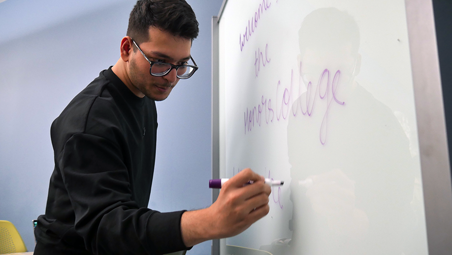 Teacher Assistant writing on a white board