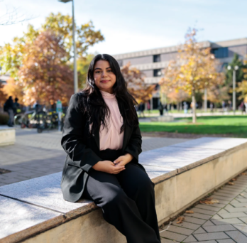 Student sitting outside on UIC campus 