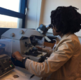 Student looking through microscope